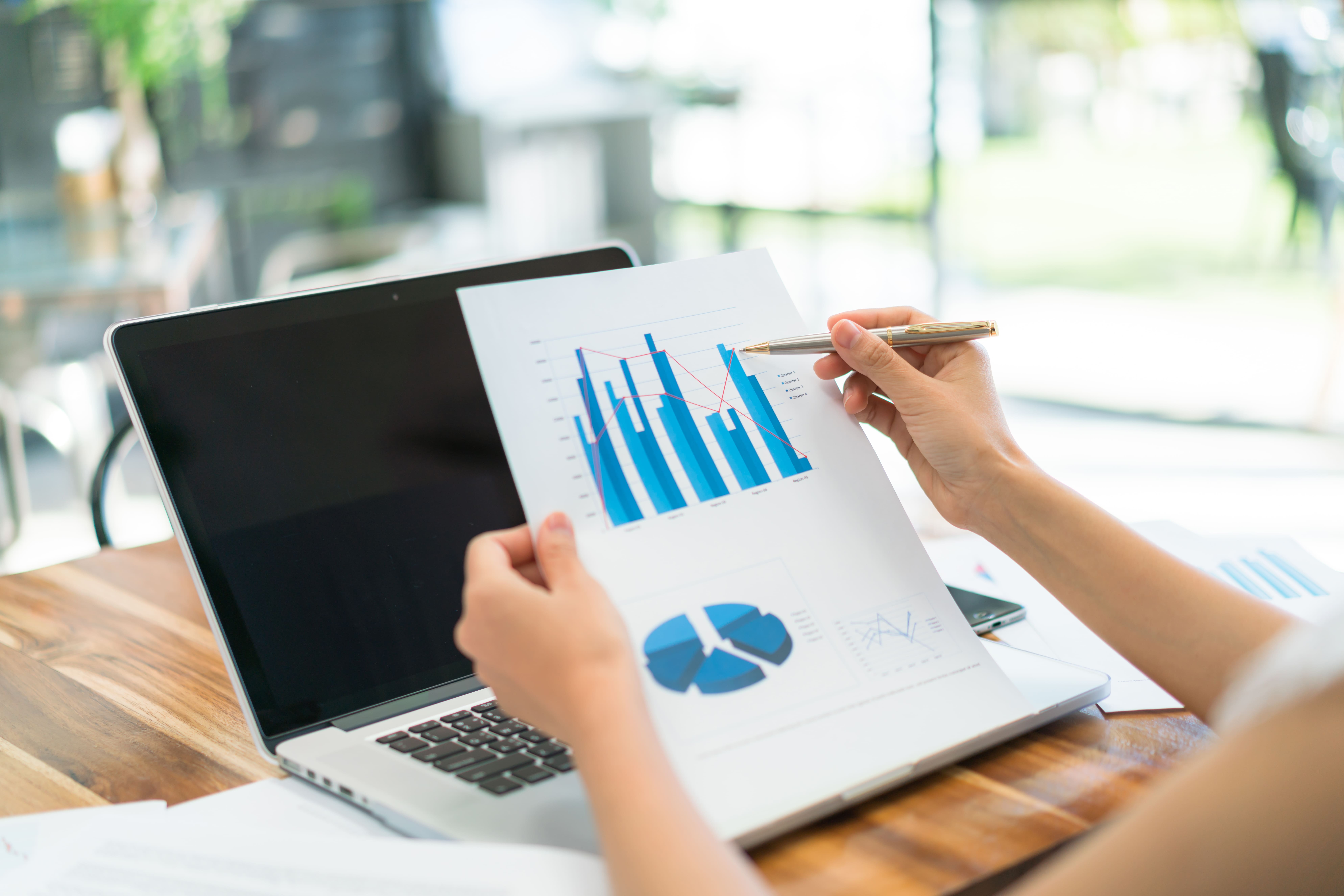 business-people-using-laptop-financial-charts-meeting-office